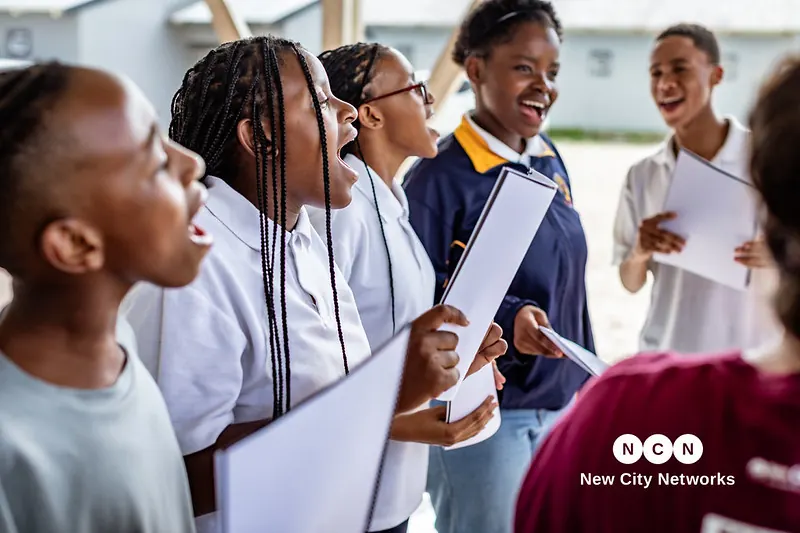 Nguzo Saba learners singing together from sheet music