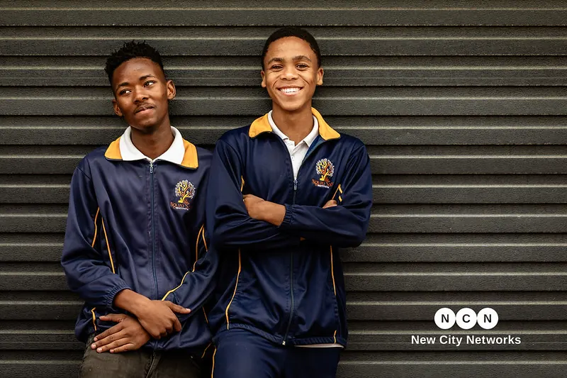 Two senior Nguzo Saba learners in the school's navy and gold tracksuit